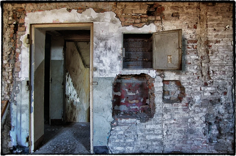 an old brick wall with two windows and a door