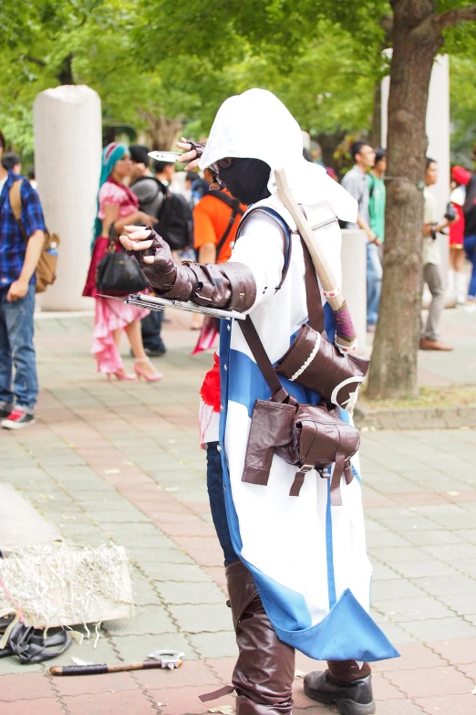 a man in armor standing next to trees