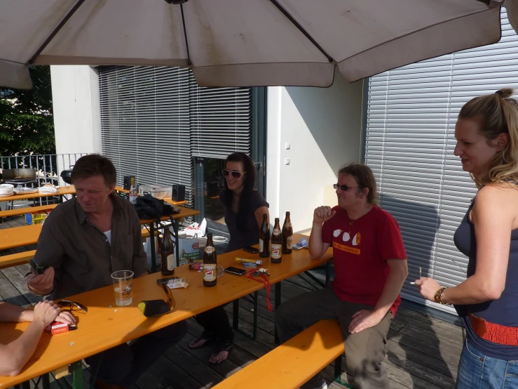 several people sitting at a long yellow table