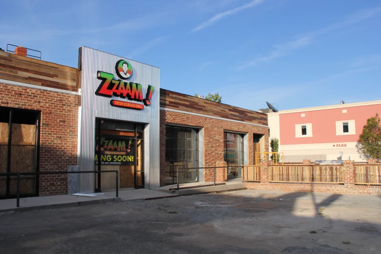 a large pizza hut sits on the corner of an industrial parking lot