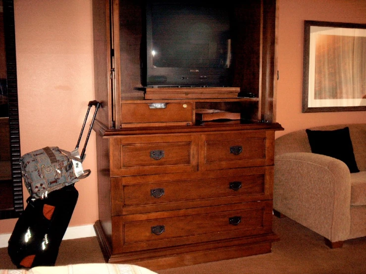 a tv and a book case sitting in a room