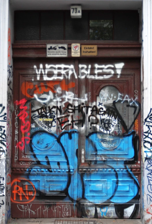 graffiti on the door and side of a building