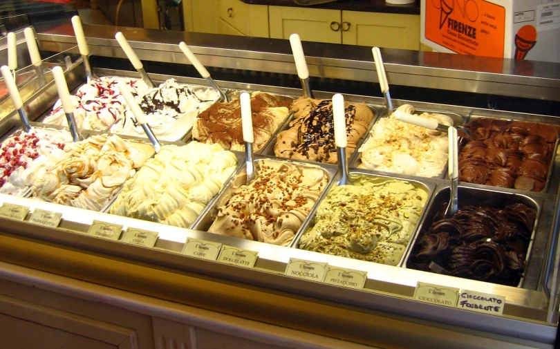 a display case with seven different flavors of desert