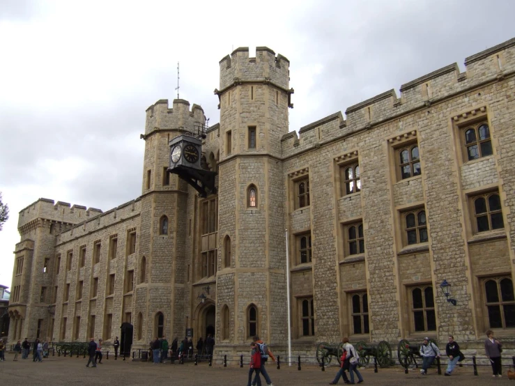 people walking on an old castle like building