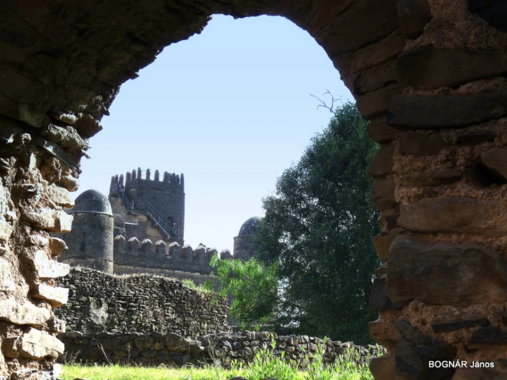 a large stone wall is shown through a stone archway