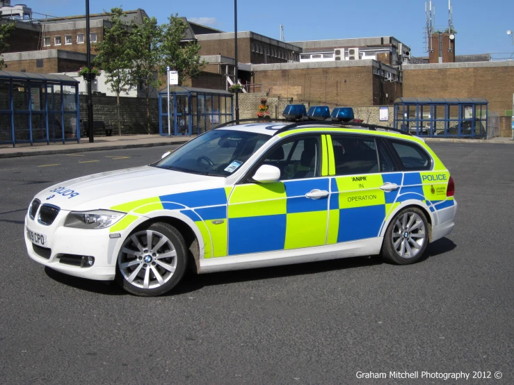 a police car parked in an urban street