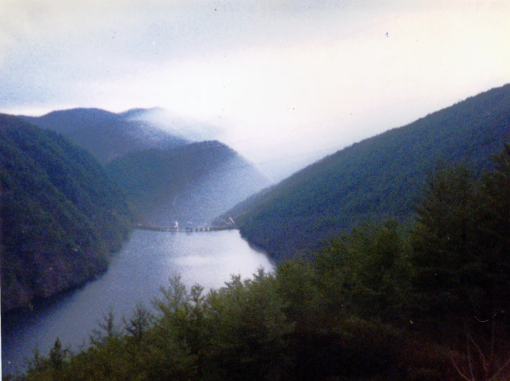 the foggy valley is near a body of water