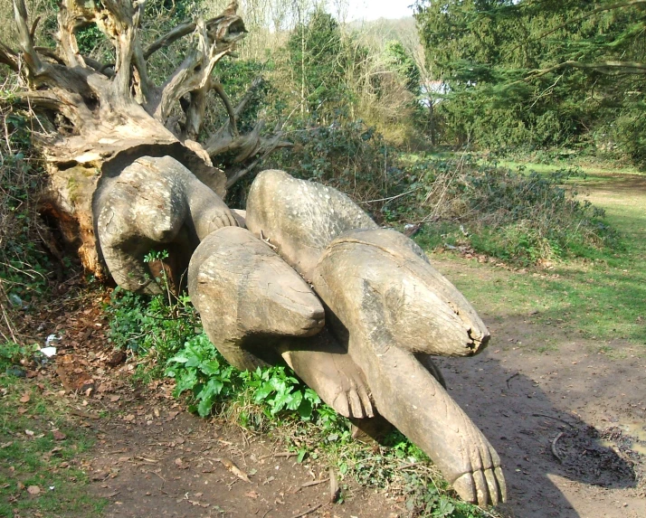 sculptures made out of logs are standing next to each other