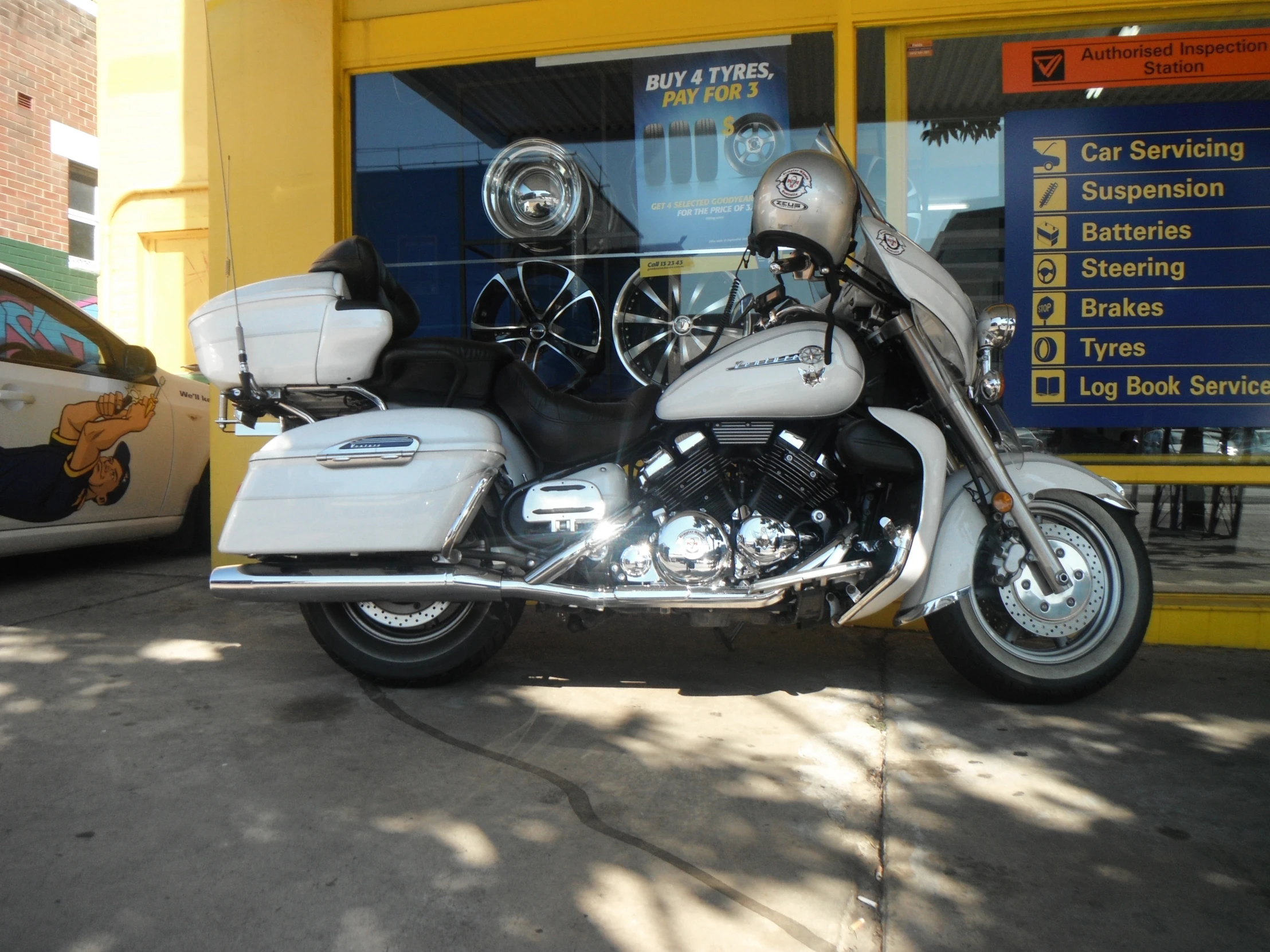 a white motorcycle parked in front of a building