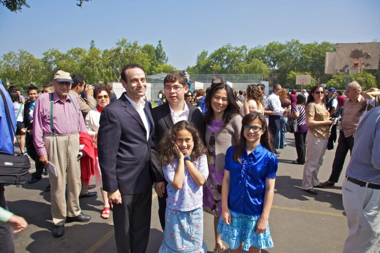 the man and two children are posing for a picture