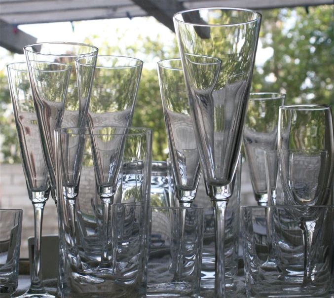 several different sized glasses are stacked next to each other