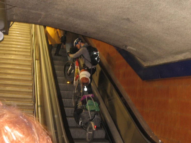 a group of people that are walking down an escalator