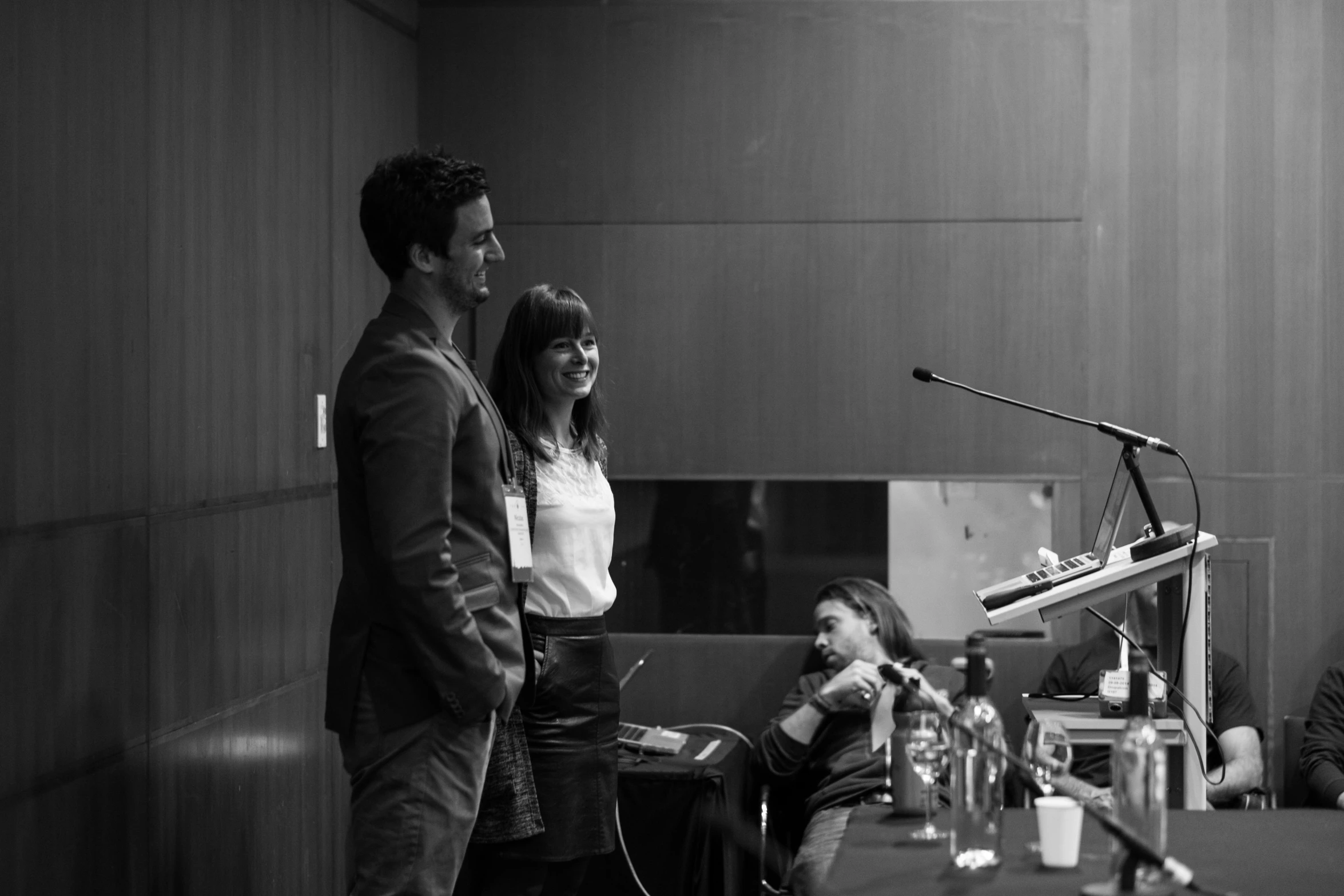 a man and woman standing in front of a microphone