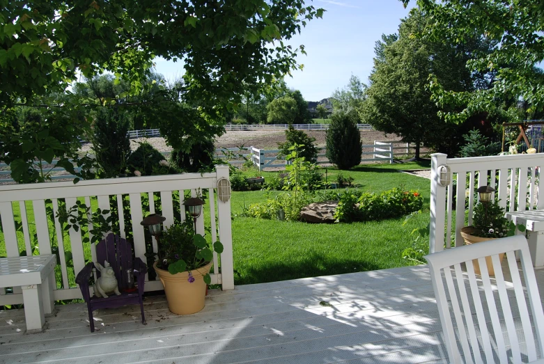 three wooden benches sit in the middle of the yard