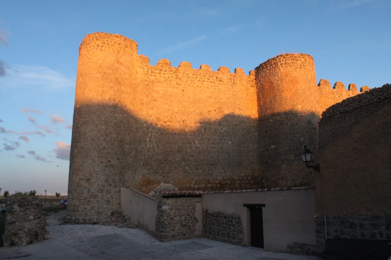 the light is shining on the walls of an old castle