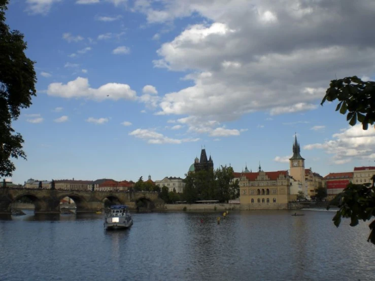 a boat in the water and a bridge