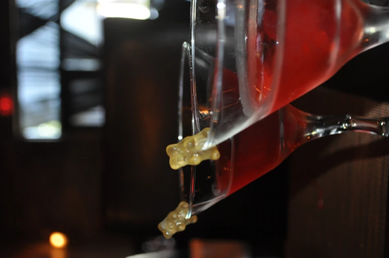 three cocktail glasses with a teddy bear on the rim and a small brown teddy bear sitting in the glass