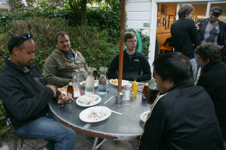 a group of people sitting at a table talking