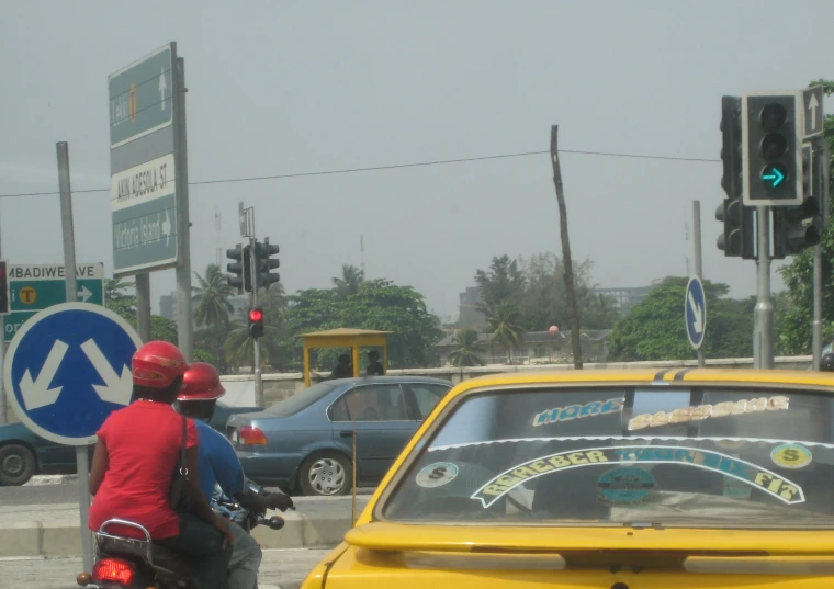 a motorcycle is stopped by traffic lights and on the street