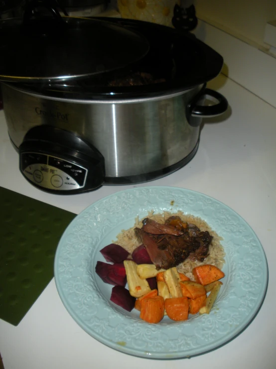 there is rice and vegetables next to a crock pot