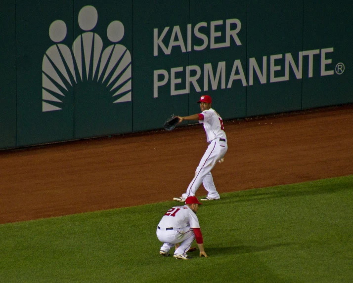 a baseball player that is jumping up in the air