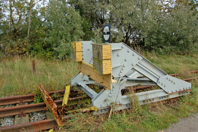 a close up of a train track with trees in the background