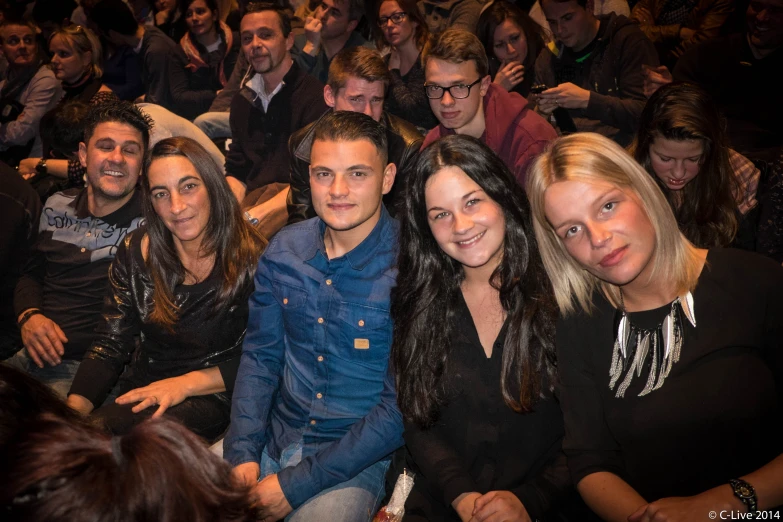 several people sitting together in a group and smiling