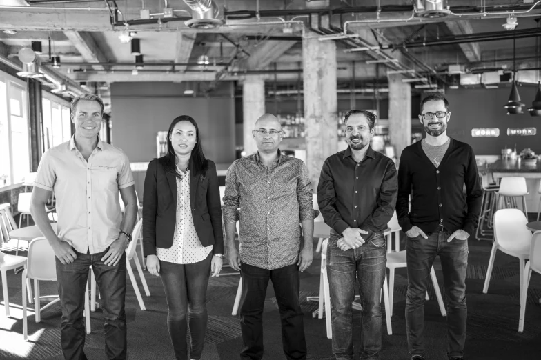 a group of people standing in a room together