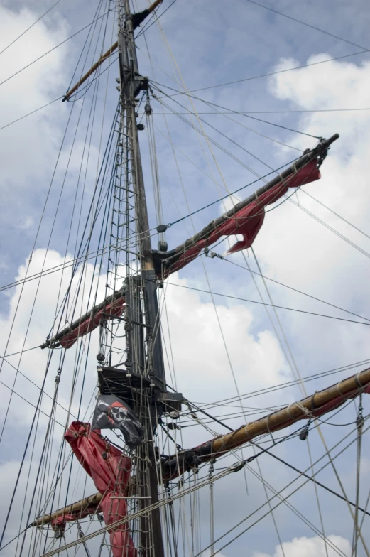 the mast of a tall ship on a cloudy day