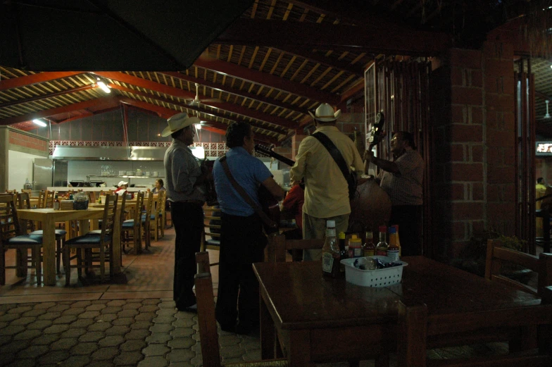 people in a restaurant looking at food on a table