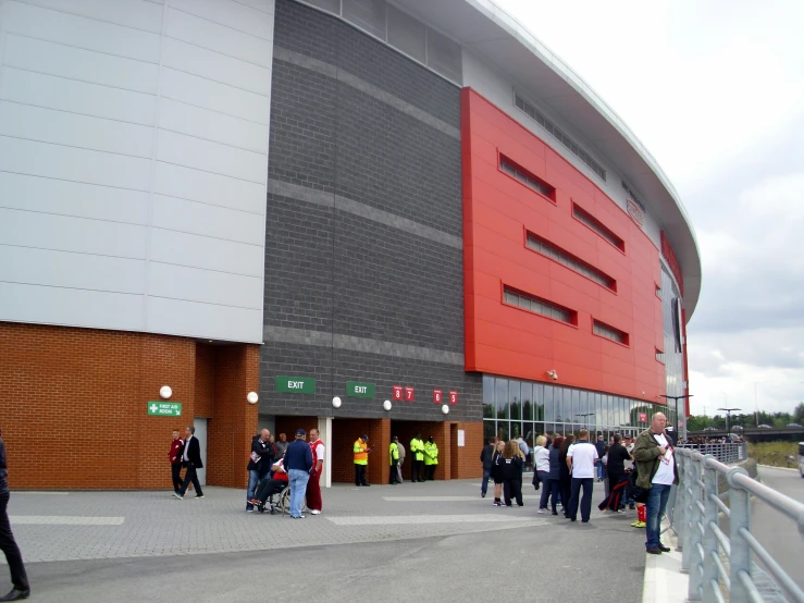 many people are gathered outside the sports arena