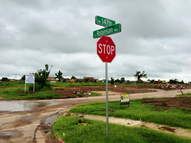 a red stop sign sitting on the side of a road