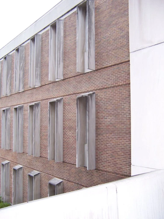 a tall building with multiple windows sitting next to a parking meter