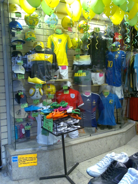 a display window of soccer jerseys and balloons