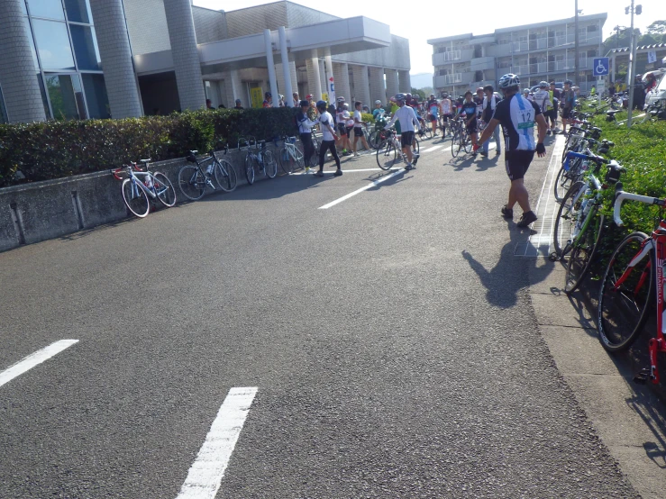 many bicycles parked in front of buildings near the street