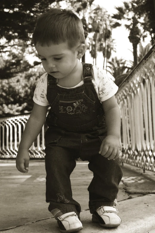 a boy sitting on top of a white rail