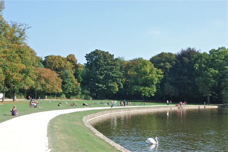 people are walking and standing near a river