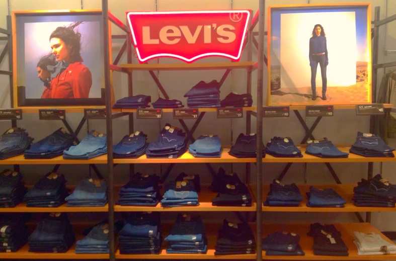 a display case with shelves and a neon sign