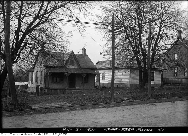 a black and white po of a small house in the suburbs