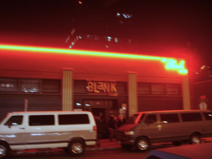 some cars are parked outside of a building