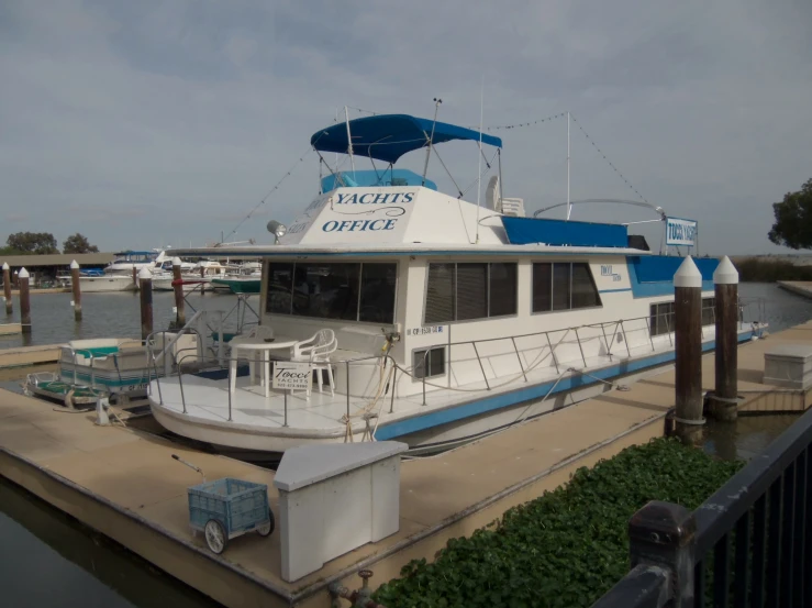 large boat docked at wooden dock in open water