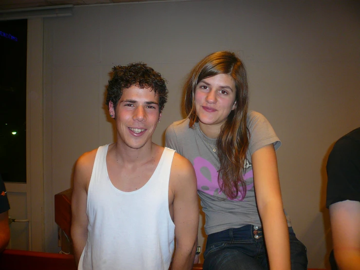 a smiling young man stands next to a smiling woman