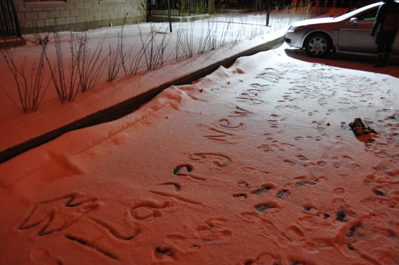 a person's car sitting on the side of a snow covered road