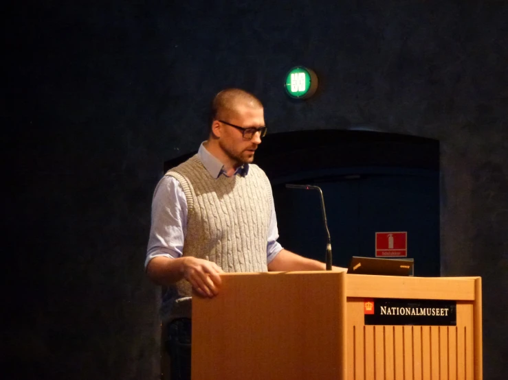 a man standing at a podium during a presentation