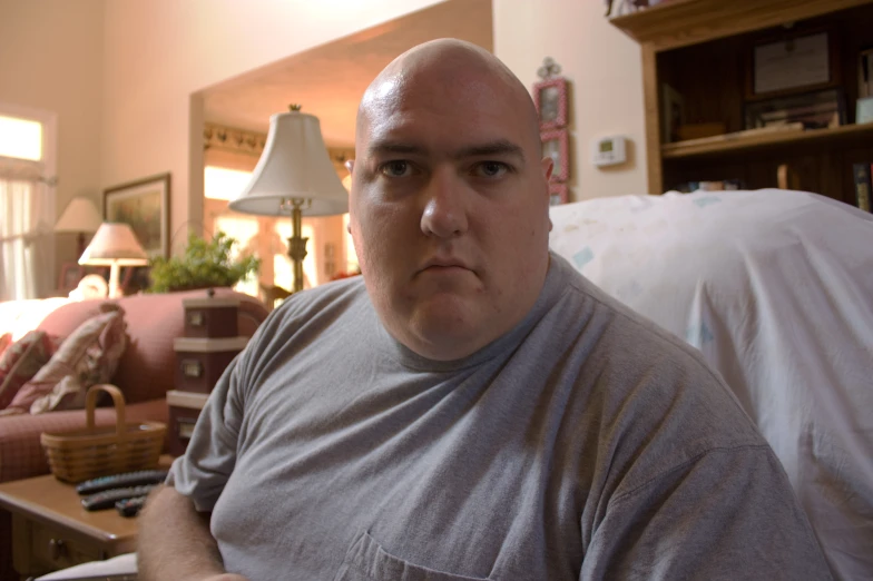 a man in gray shirt standing in a living room