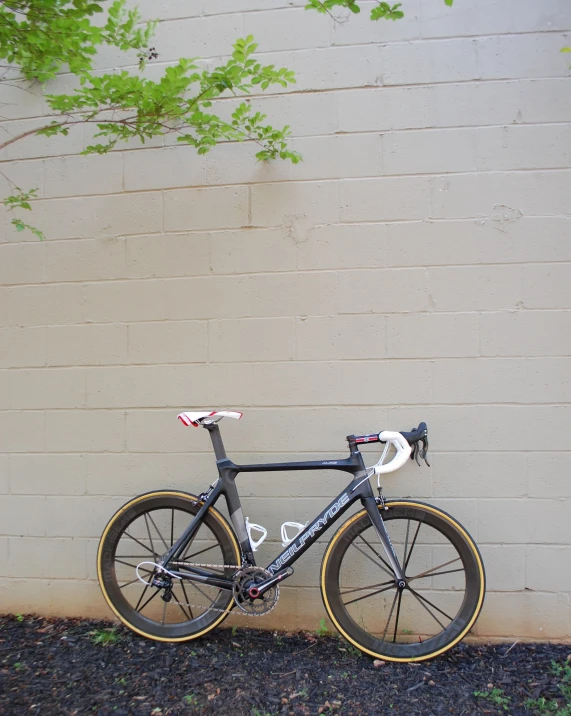 a road bike leaning against the wall
