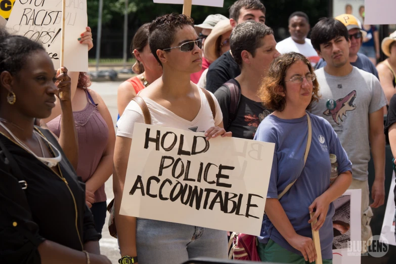 people are standing together and protesting with signs