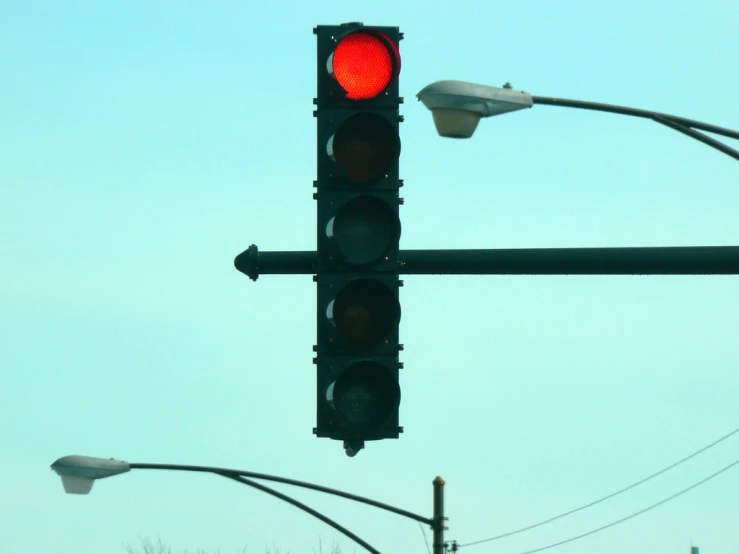 a traffic light with two traffic cameras on top of it