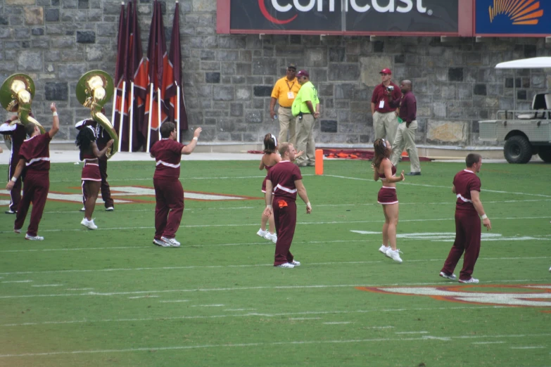 some people standing on a field holding up some trophies