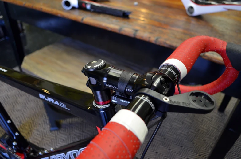 close up of bicycle handlebars with orange levers